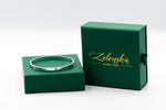 Silver bracelet on a green box with 'Zelenska Jewellery' branding.