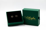 Green jewelry box with 'Zelenska Jewellery' branding and flower-shaped earrings inside.