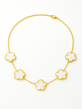 Gold necklace with white floral pendants on a white background