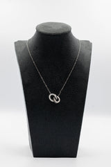 Necklace with a pendant on a black mannequin bust against a white background