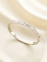 Silver ring on a light beige background